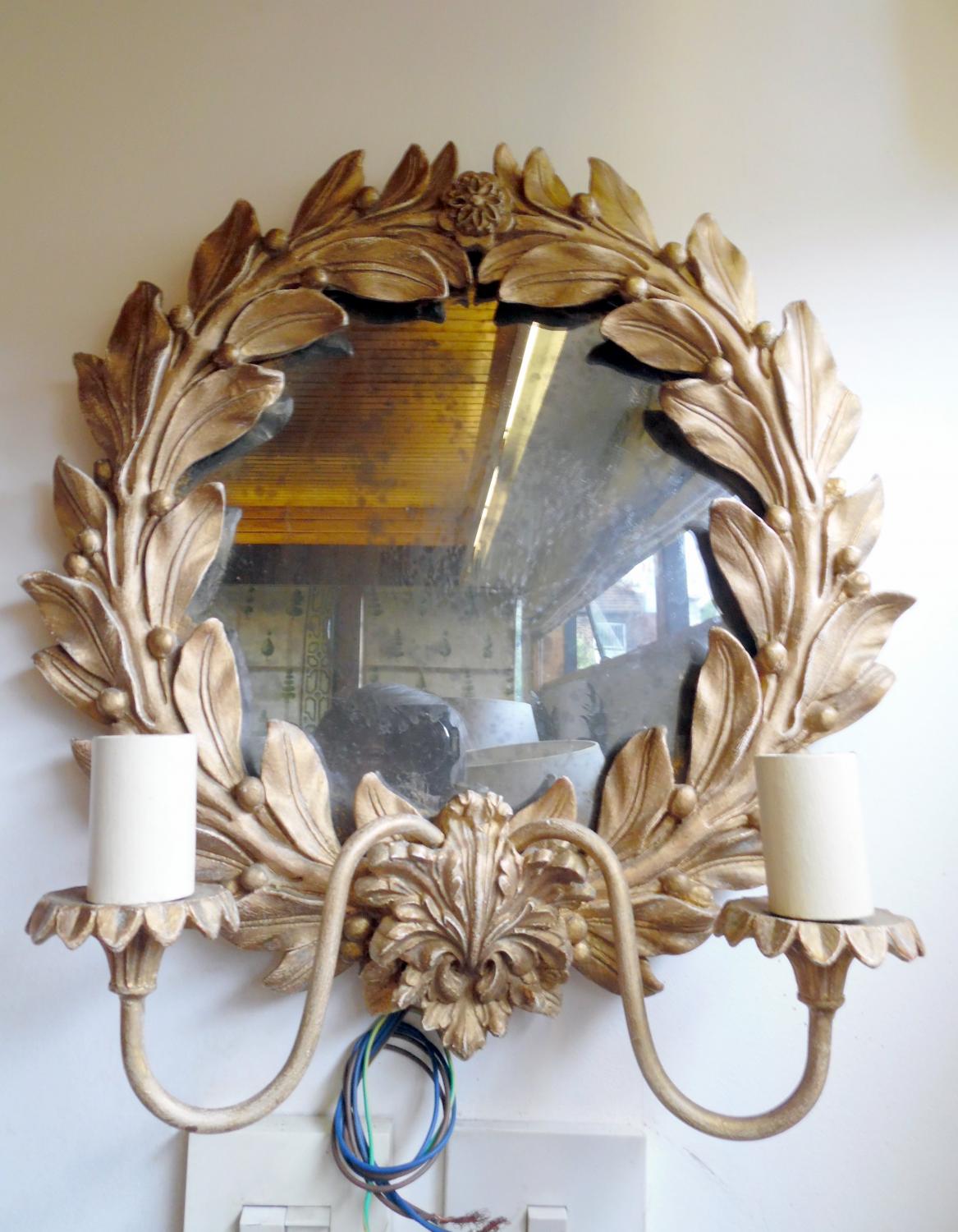 Mirrored wall sconce with gilded leaves