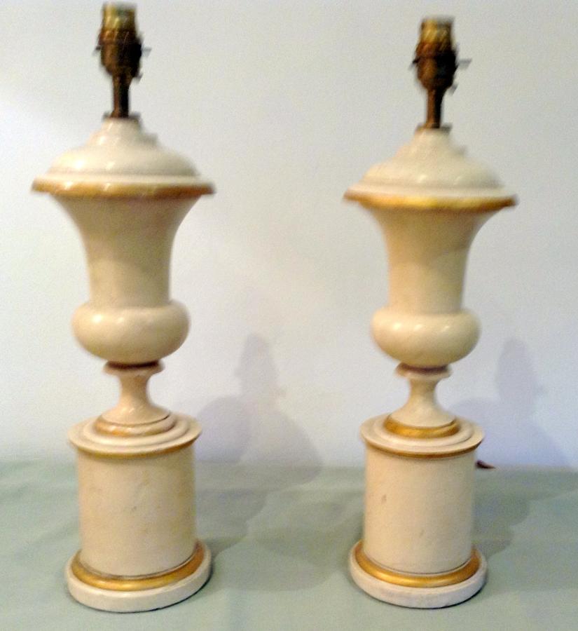Cream and gilt wooden urns
